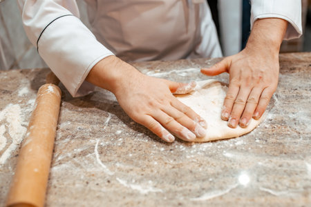 The cook prepares a dish of dough. Close-up