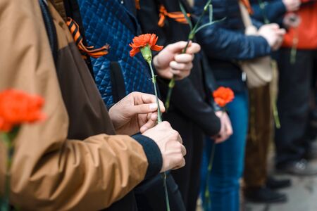 Victory Day. Red carnation in handsの写真素材