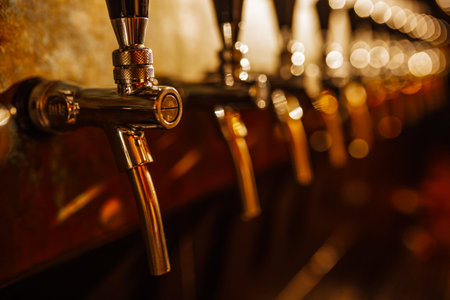 Details of the beer bar. Beer taps in a row in perspective. Warm tinting, different focus.  Close up...