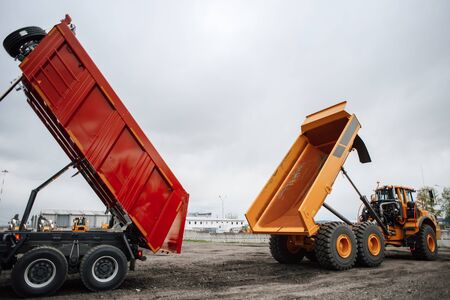 Two construction dump trucks at a special machinery exhibitionの写真素材