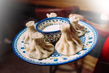 Plate with Georgian cuisine dish - khinkali and sauceの写真素材