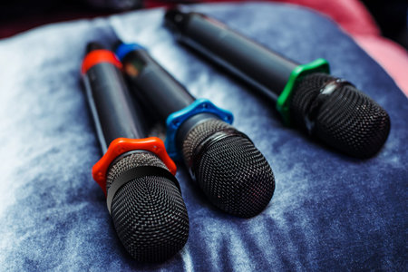 Three karaoke microphones are on the table