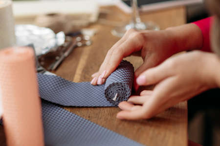 DIY wax candle making process. Woman making decorative wax candle, close-up of handsの写真素材