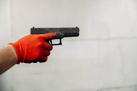 Shooting range. Rear view of men shooting with gun in shooting range