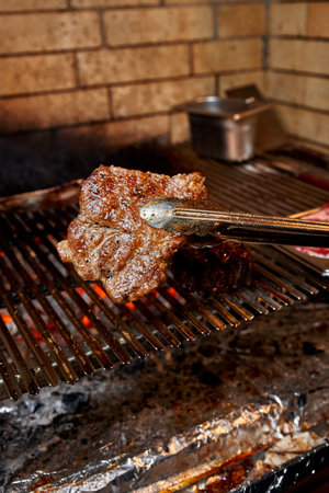 Chef grilling steak on the charcoalの写真素材