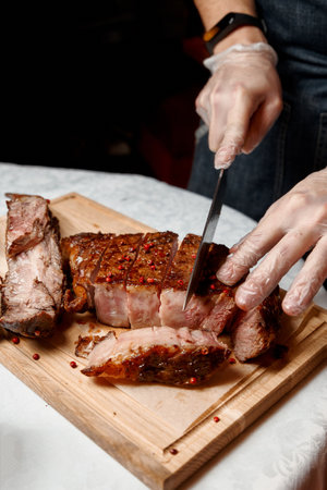Chef cutting meat to serve to the customersの写真素材