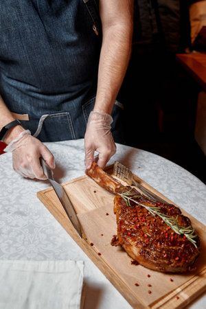 Chef cutting meat to serve to the customersの写真素材