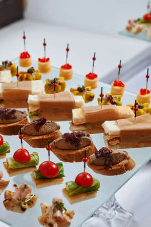 Ð¡atering. Banquet table with different snacks and dessertsの写真素材