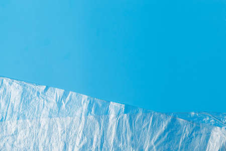 transparent plastic bag on a blue background. The global problem of environmental pollution. Copy space, texture, backgroundの写真素材