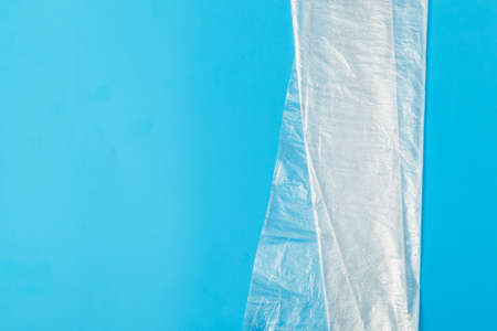 transparent plastic bag on a blue background. The global problem of environmental pollution. transparent plastic bag on a blue background. The global problem of environmental pollution. Copy space, texture, backgroundの写真素材