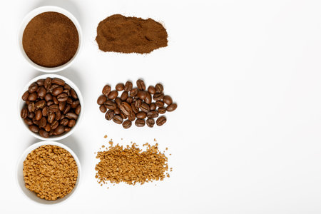 coffee beans, ground and black coffee or espresso in mugs and sprinkled on a white background....