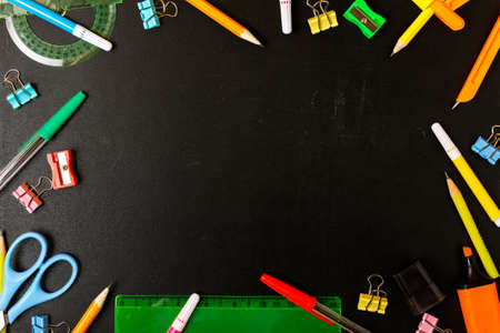 Frame of school stationery on a black school board. Concept back to school. School shop concept. Copy space, flat lay, top view, background.の写真素材