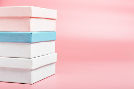 Three boxes on a pink background. Shopping concept, seasonal sale. Background for text, copy space.