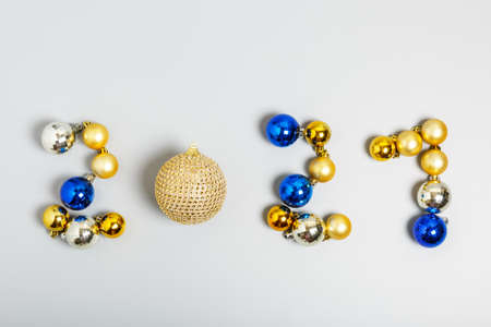 numbers 2021 made of gold, silver and blue Christmas balls on a gray background. New Year 2021 celebration concept. top view, flat layの写真素材