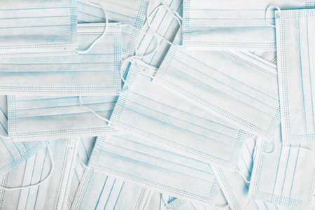 background of blue medical surgical masks. medical texture and background. concept of protection against virus during a pandemic and quarantine.の写真素材