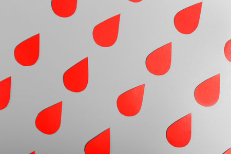 Pattern of drops of blood on a gray background. World Hemophilia Day. World Blood Donor Day.の写真素材