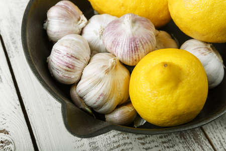 lemon and garlic on a black plate. Vitamin C.の写真素材