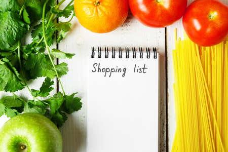 Shopping list for the supermarket. Food: Pasta, tomatoes, apples.の写真素材