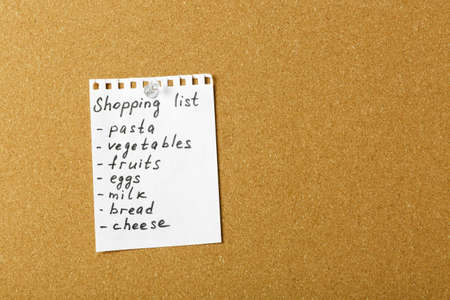 Shopping list for the supermarket on cork board. Copy space.の写真素材
