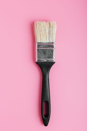 black paint brush on a pink background. concept of art store, drawing school or hobby. copy space,...
