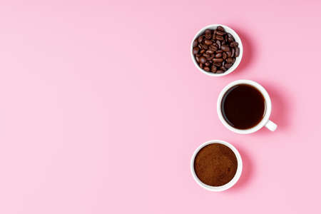 coffee beans, ground and black coffee or espresso in mugs on a pink background. coffee shop or store concept. concept of making coffee. copy space, top view, minimalism.の写真素材