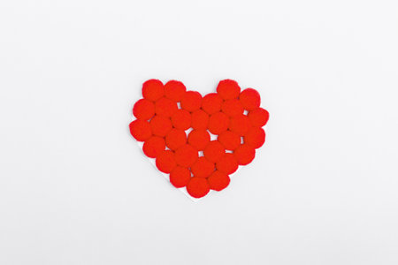 Red soft plush heart on a grey background. The concept of Valentine's day, love, dating and wedding. minimalism, copy space, background for designの写真素材