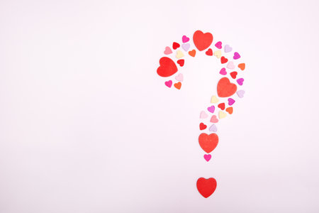 Question symbol made from hearts on a gray background. Marriage proposal symbol. The concept of love and romance. Copy space.の写真素材