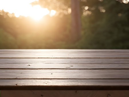 Empty wooden table top with lights bokeh on blur morning background.の素材
