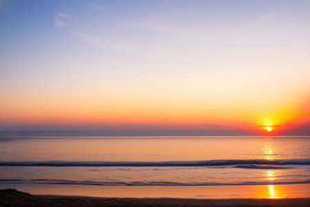 Closeup sea sand beach landscape, Orange and golden sunset sky. Generative AIの素材