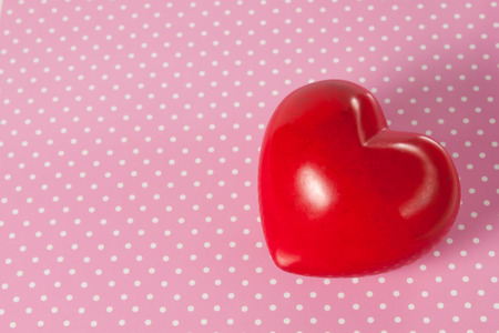 red heart on a background with polka dotsの写真素材