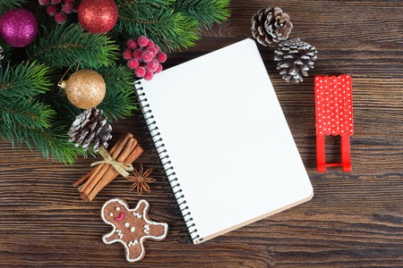 Christmas fir tree with decoration and empty note on brown wooden boardの写真素材