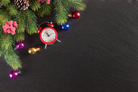 New Year background with Christmas tree and decorations on black slate surface. Top view.の写真素材