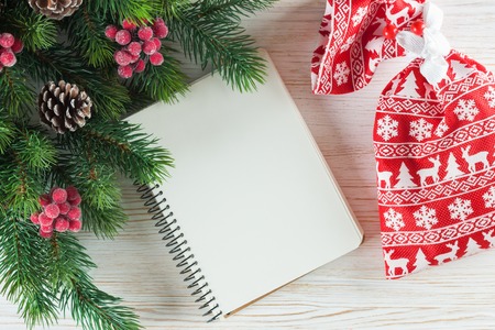New Year background with Christmas tree and empty note greeting card on white wooden surface. Top view.の写真素材