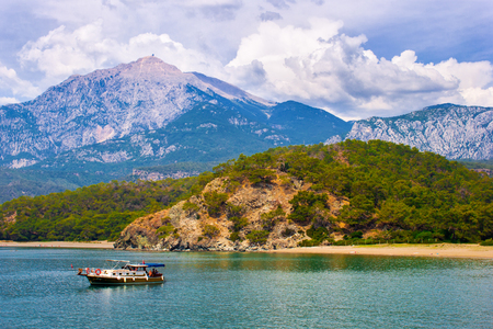 beautiful seascape. summer day in a bay with mountains and fantastic sky and a boat. Turkey. Antalya.の写真素材