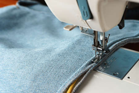 sewing machine. the process of sewing a decorative cord of blue fabric.の写真素材