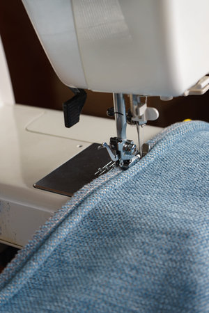 Professional equipment. Modern sewing machine with special pressure foot. The process of sewing a...