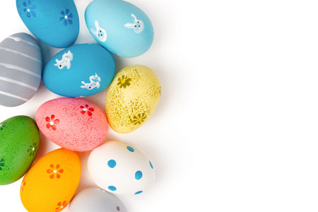 Colorful easter eggs isolated on whtie background. Easter mockup, top view, flat lay with copy spaceの写真素材