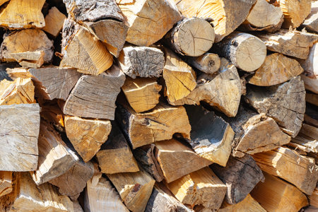 Pile of firewood, stacked dry chopped firewood logs . Preparation of fiewood for winter. Wooden...