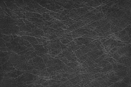 Genuine black coarse textured leather, eco-friendly leatherette background. Material for upholstery and interior design, sports items and clothes. Wallpaper, banner, backdrop.の写真素材