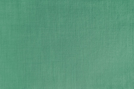 Texture background of green linen fabric. Textile structure, cloth surface, weaving of natural cotton fabric closeup, backdrop, wallpaper.の写真素材