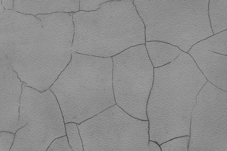 Old stucco plaster surface with cracks, close up grunge texture of gray painted cement, concrete...
