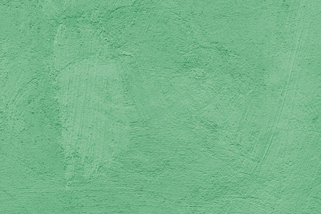 Old stucco plaster surface, brushstroke background, close up grunge texture of green painted cement, concrete wall texture. Wallpaper, backdrop, architecture design elementの写真素材