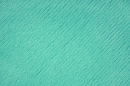 Turquioise knitted woolen jersey fabric with diagonal weaving, sweater, pullover texture background....