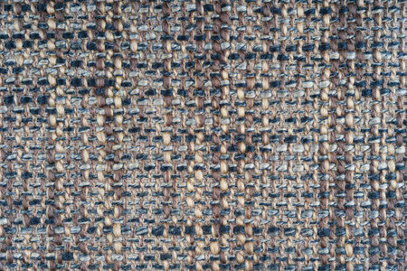 Texture of brown jacquard fabric of rough weave macro, close up. Mixed color, melange cloth....