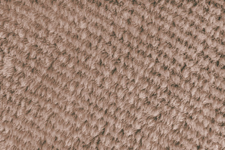Terry cloth, diagonal striped pattern brown towel texture background. Soft fluffy textile bath or...