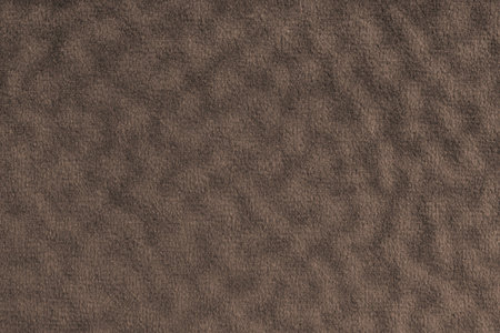 Faux fur, velours brown fabric or cloth with wavy effect. Fluffy fabric of artificial fur textile...
