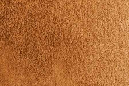 Close up, macro structure of orange suede fabric with abstract embossed shabby, messy texture. Upholstery, decorative cloth structure, canvas for home decor. Background, backdrop, wallpaper.の写真素材