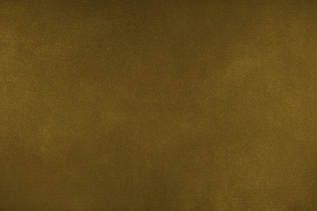 Abstract grungy texture background with different shades of dark matte yellow color. Painted canvas, concrete surface, studio backdrop, grainy textured effectの写真素材