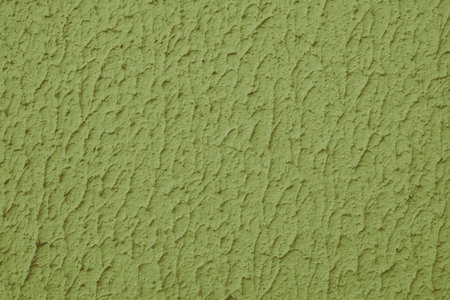 Close up of textured khaki color painted wall with rough stucco, plaster wall texture. Vibrant background, wallpaper, backdrop, design element.の写真素材