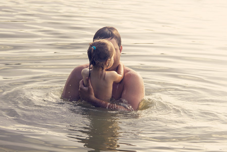 Father and Daughter Playing Together at the sea at Sunset.の写真素材